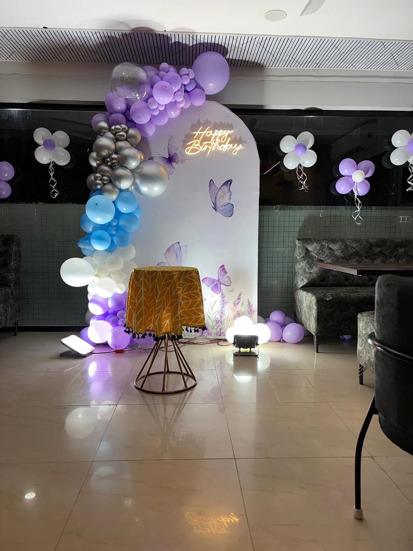 banquet hall, balloon arch and neon 'Happy Birthday' sign, close view