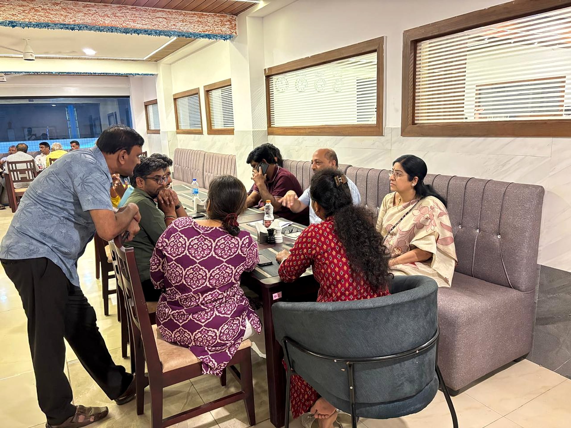 restaurant, large group seated for a family meal, wide angle