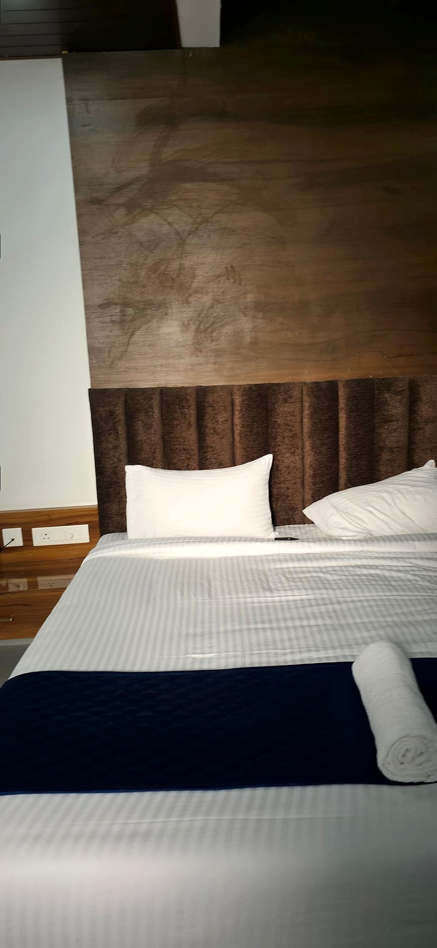 dark tufted headboard close-up, slightly blurry