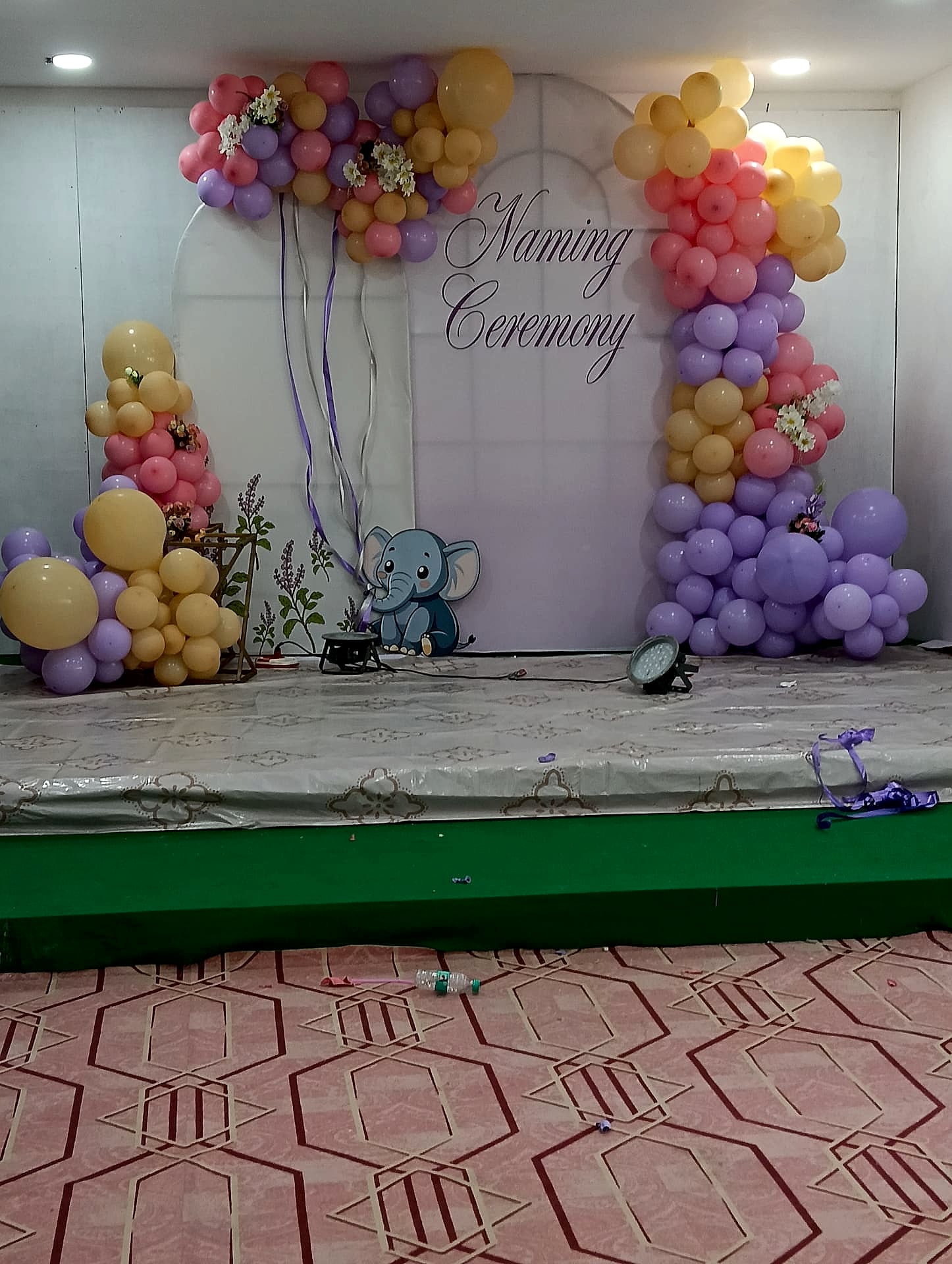 banquet hall decorated for a 'Naming Ceremony' event - evidence of function hall, not generic marketing use