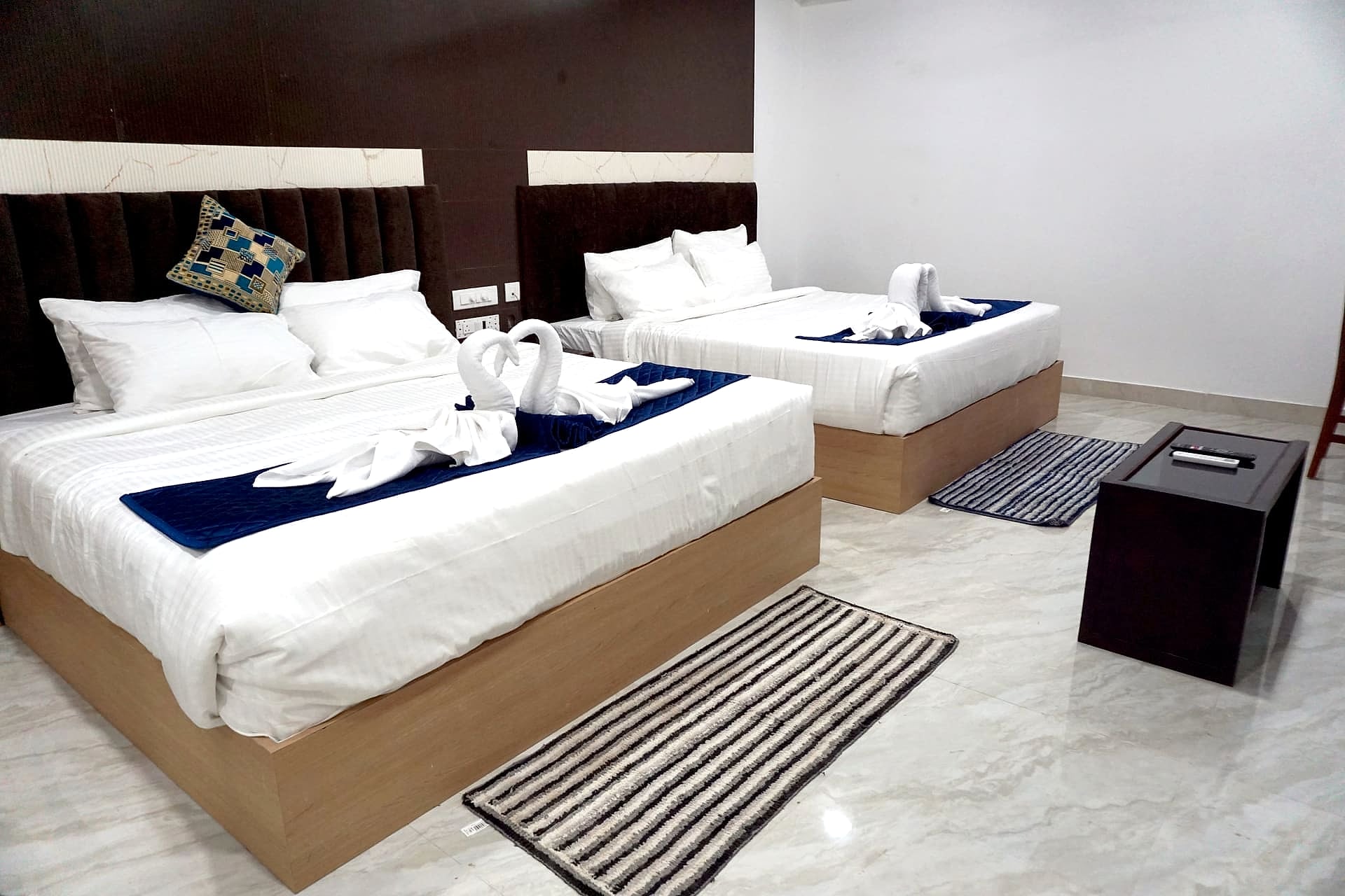 twin/triple beds, brown tufted headboard, marble floor
